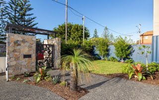 Bar Beach - Urban Oasis - Stone wall entry with laser cut metal gate