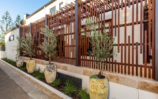 Bar Beach - Urban Oasis - Timber screening with roadside planter pots and native grass garden